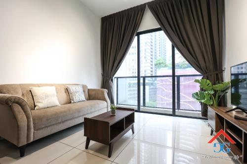a living room with a couch and a tv at Astoria Ampang By Grabstay in Kuala Lumpur