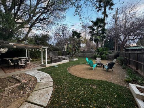 a patio with chairs and a table in a yard at Cozy and Comfy Tree House in Los Angeles