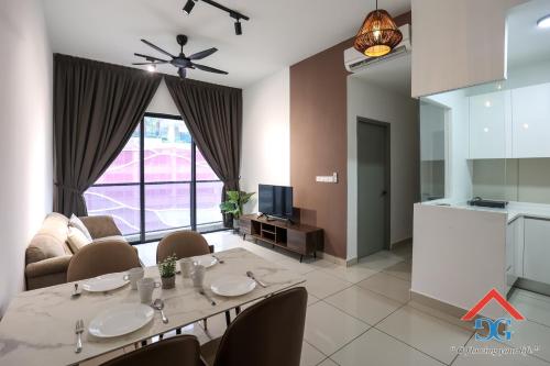 a living room with a dining table and a kitchen at Astoria Ampang By Grabstay in Kuala Lumpur