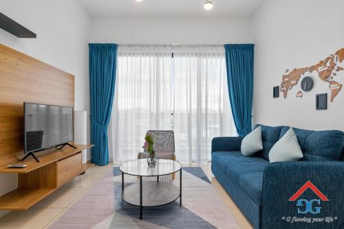 a living room with a blue couch and a tv at Astoria Ampang By Grabstay in Kuala Lumpur