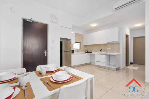 a kitchen and dining room with a table and chairs at Astoria Ampang By Grabstay in Kuala Lumpur