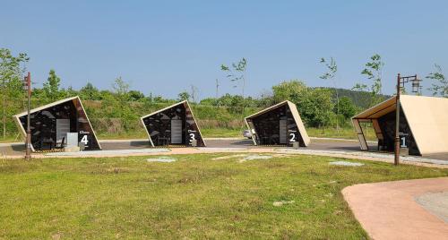 a group of three bus shelters in a park at Starium Seocheon in Seocheon