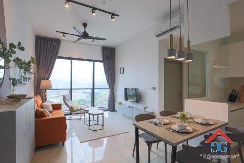 a living room with a table and a dining room at Astoria Ampang By Grabstay in Kuala Lumpur
