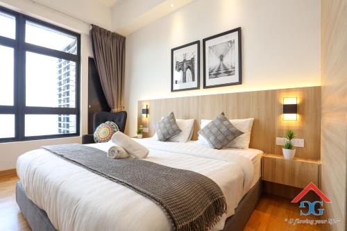 a bedroom with a large bed and a window at Astoria Ampang By Grabstay in Kuala Lumpur
