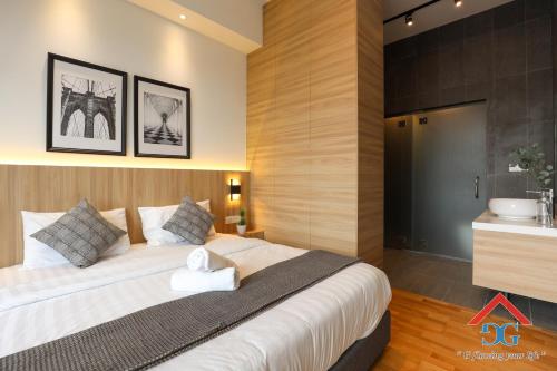 a bedroom with a large bed and a sink at Astoria Ampang By Grabstay in Kuala Lumpur