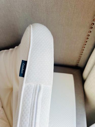 a white tie sitting on top of a bed at The Riverside Mountain Lodge - 110sqm clam luxury - including bed linens, towels, in Idre