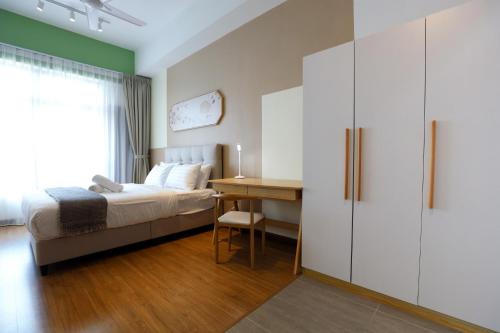 a bedroom with a bed and a desk at Astoria Ampang By Grabstay in Kuala Lumpur
