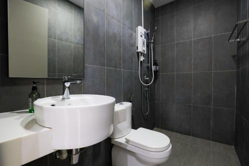 a bathroom with a white sink and a toilet at Astoria Ampang By Grabstay in Kuala Lumpur