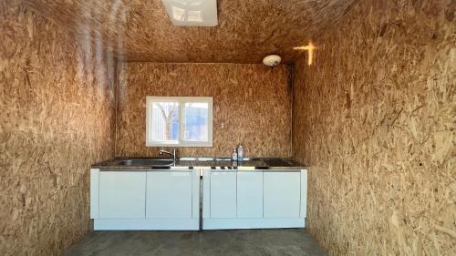 a kitchen with a sink and a window at Starium Seocheon in Seocheon