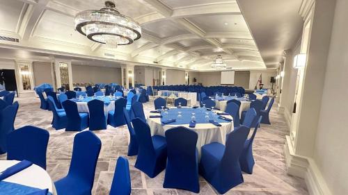 a large banquet hall with blue tables and chairs at Grand Regal Hotel Davao in Davao City
