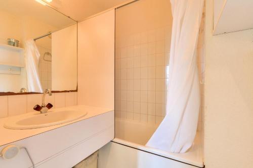 ein Bad mit einem Waschbecken und einem Spiegel in der Unterkunft Résidence Port Bourgenay - maeva Home - Appartement 2 pièces 4 personnes - 604 in Talmont