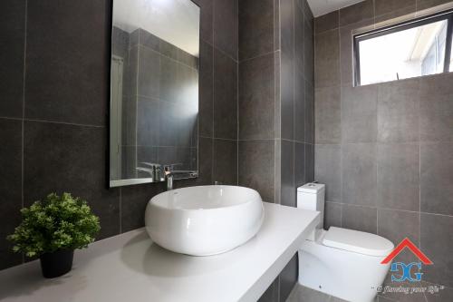a bathroom with a white sink and a toilet at Astoria Ampang By Grabstay in Kuala Lumpur