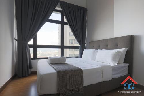 a bedroom with a large bed with a large window at Astoria Ampang By Grabstay in Kuala Lumpur