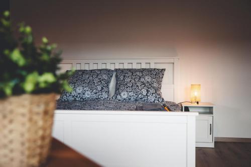 a bedroom with a bed with a white headboard at Kinsau Rooms in Kinsau