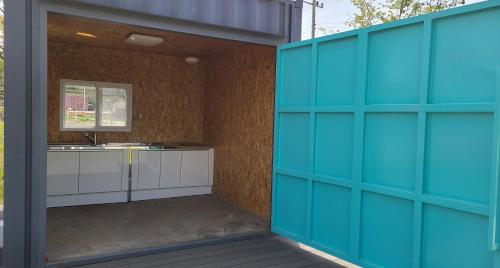 a bathroom with a blue door and a sink at Starium Seocheon in Seocheon