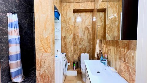 La salle de bains est pourvue de 2 lavabos et d'une douche. dans l'établissement Уютная 2-комнатная квартира в центре г. Алматы, à Almaty
