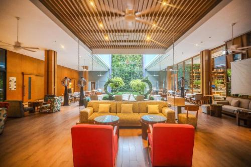 a lobby with a couch and tables and chairs at Holiday Inn Express Phuket Patong Beach Central by IHG in Patong Beach