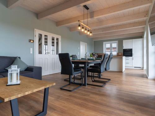 a dining room and living room with a table and chairs at Doppelhaushälfte in Karolinenkoog in Karolinenkoog