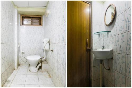 a bathroom with a toilet and a sink at Hotel YSM Grand in Tezpur