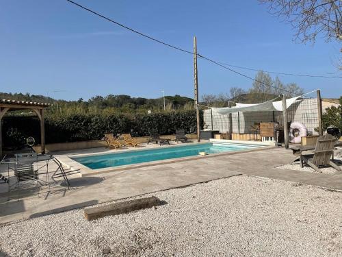 a swimming pool in a yard with a tent at Pooh’s Belle in Grimaud