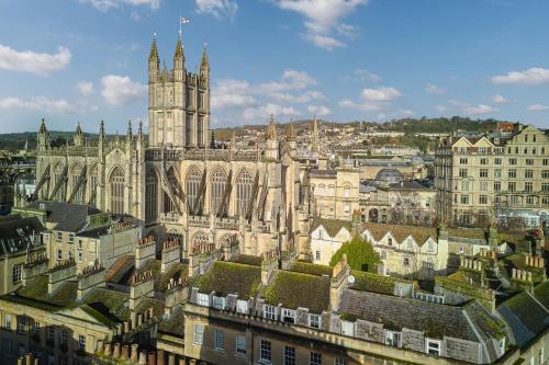 an old building with a clock tower in a city at Abbey Hotel Bath, a Tribute Portfolio Hotel in Bath