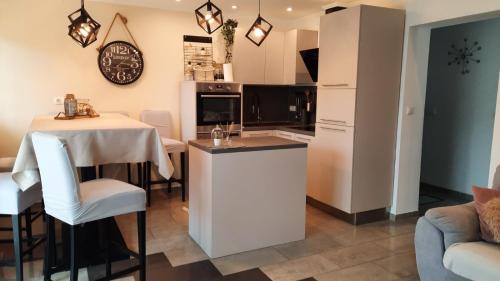 a kitchen and living room with a small table and a counter at Apartment Dino in Selce