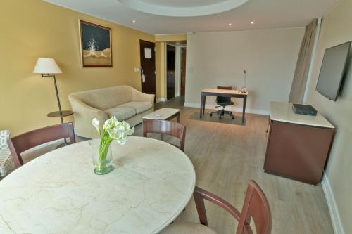 a living room with a table and a couch at Sheraton Guayaquil in Guayaquil