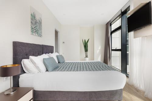 Ένα ή περισσότερα κρεβάτια σε δωμάτιο στο Bellevue Residence Suites