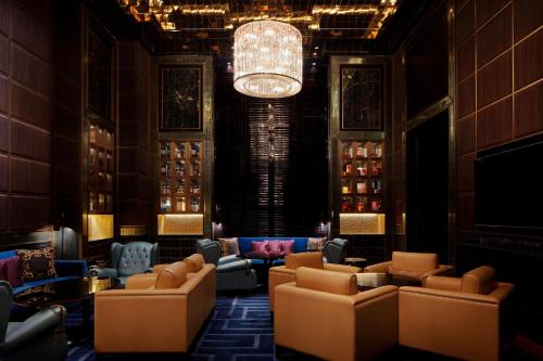 a lobby with couches and a chandelier at The St. Regis Kuala Lumpur in Kuala Lumpur