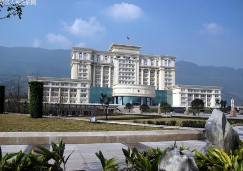 a large white building with a park in front of it at Wuyu Hotel, Jingyun Mountain & Zhuangyuanbei Light Rail Station in Beibei District in Chongqing