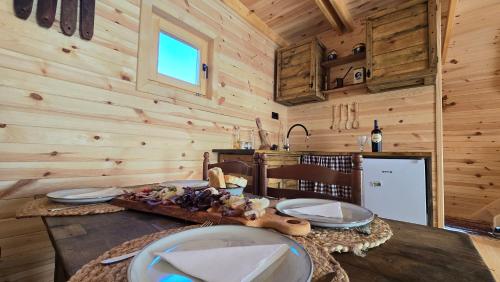 a dining room with a table in a wooden cabin at Etno Villas Tara&Petra in Žabljak
