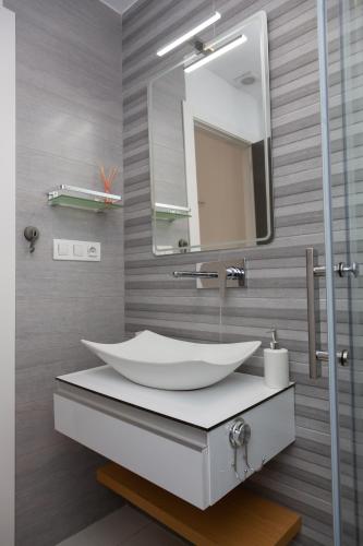 a bathroom with a white sink and a mirror at Playa Elisa Bay app 411 in Pilar de la Horadada