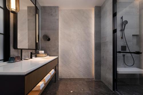 a bathroom with two sinks and a shower at Sheraton Taiyuan in Taiyuan