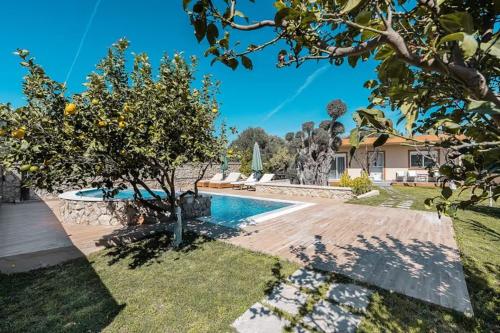 a house with a swimming pool in a yard at Villa MATA - 600m² with Private Pool and Jacuzzi in Kalithies