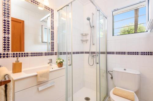 a bathroom with a shower and a toilet and a sink at Villa Nero by Villa Plus in Son Parc