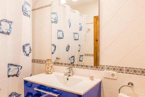 a bathroom with a sink and a mirror at Villa Camamilla by Villa Plus in Alaior