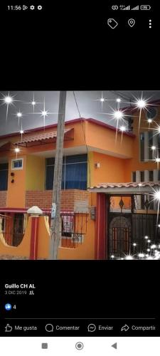 a picture of a house with lights on it at Juyanis Hostal in Otavalo