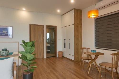 a living room with a table and a dining room at Hanoi Shouten - Staycation in Hanoi