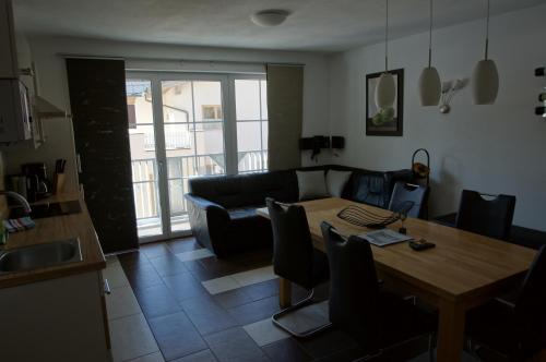 a living room with a table and a couch at Alpinchalet Eder - Steiner in Saalbach-Hinterglemm