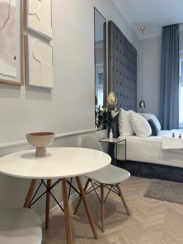 a bedroom with a bed and a table and chairs at MINT Boutique Studio Apartments in Zagreb