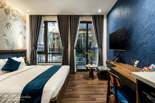 a hotel room with a bed and a television at KunKin Garden Aparthotel in Ho Chi Minh City