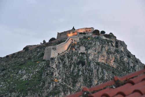 a castle on the side of a mountain at Porto Nafplio in Nafplio