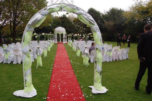a wedding aisle with white chairs and a red carpet at Elsje's Country Inn in Kempton Park