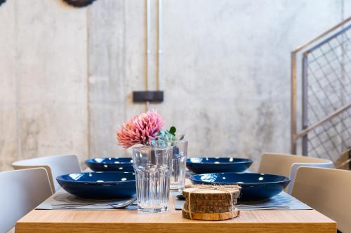 a table with blue bowls and a flower in a vase at ART LOFTS Valencia by Benisur in Valencia