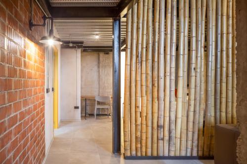 a hallway with bamboo pipes in a building at ART LOFTS Valencia by Benisur in Valencia