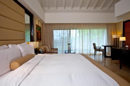 a large white bed in a hotel room at Casa de Campo Resort & Villas in La Romana