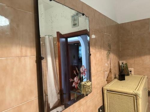 a mirror on a wall in a bathroom at Casa Vacanze IL Giardino delle Emozioni in Montecarotto