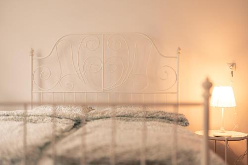 a bed with a white headboard in a bedroom at OderPoint#Sauna#Jacuzzi in Gozdowice
