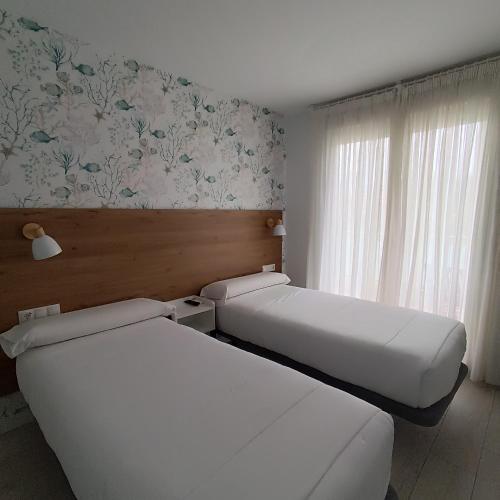 Ένα ή περισσότερα κρεβάτια σε δωμάτιο στο Hotel Rodeiramar 2A