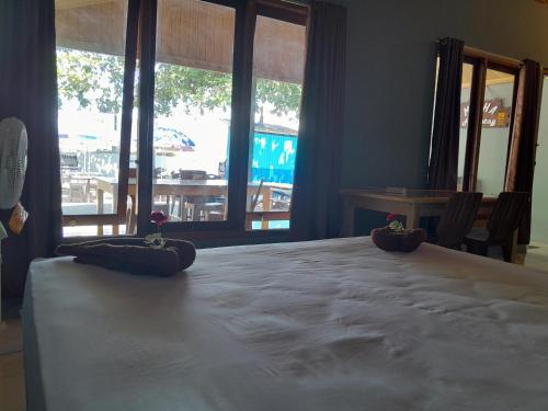 a room with a large table with two pillows on it at Mikha Homestay BUNAKEN in Manado